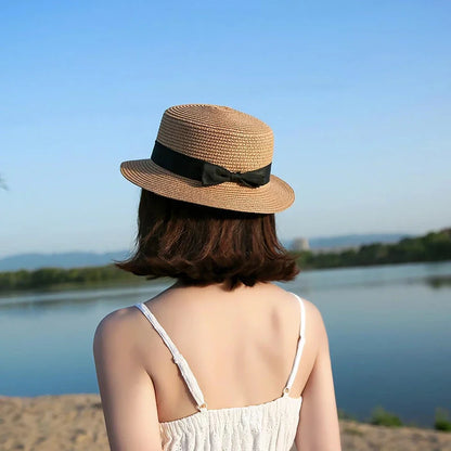 Classic straw Panama hat with a bow detail, offering sun protection and fashionable summer style