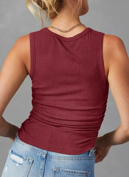 A sleeveless ribbed knit tank top for women in a variety of colors and sizes, featuring a crew neck design and pleated details for a stylish, casual look.