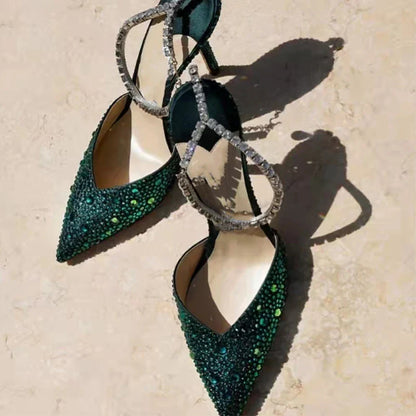Glamorous rhinestone-embellished stiletto sandals in black and green colors, featuring a pointed toe and sleek silhouette