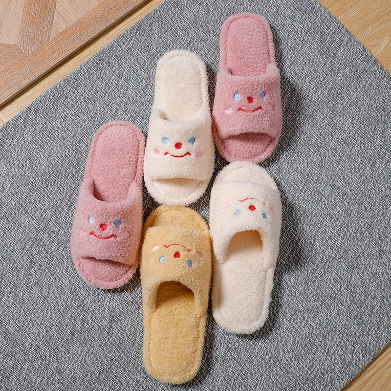 Cozy plush slippers with a smiling face design for comfortable indoor wear