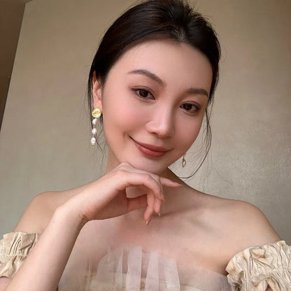 Elegant gold coin long earrings with a luxurious, statement-making design