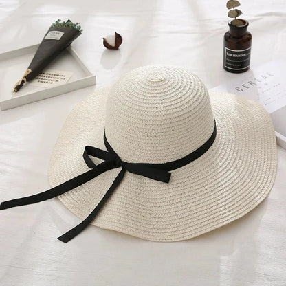 Fashionable summer straw hat for women with wide brim and bow detail, providing UV protection and stylish look