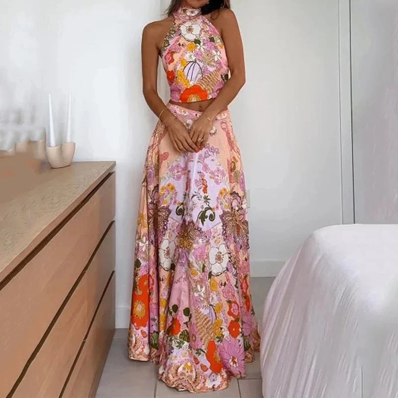 Stylish sleeveless midi skirt suit with vibrant floral print, featuring a half-turtleneck design and comfortable A-line silhouette.