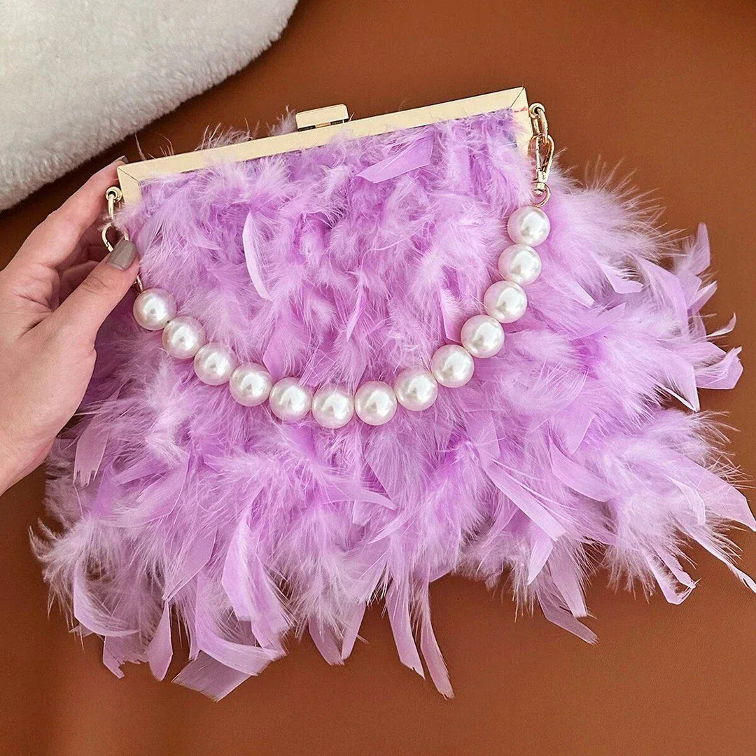 Elegant feather clutch bag with pearl embellishments and metal chain details