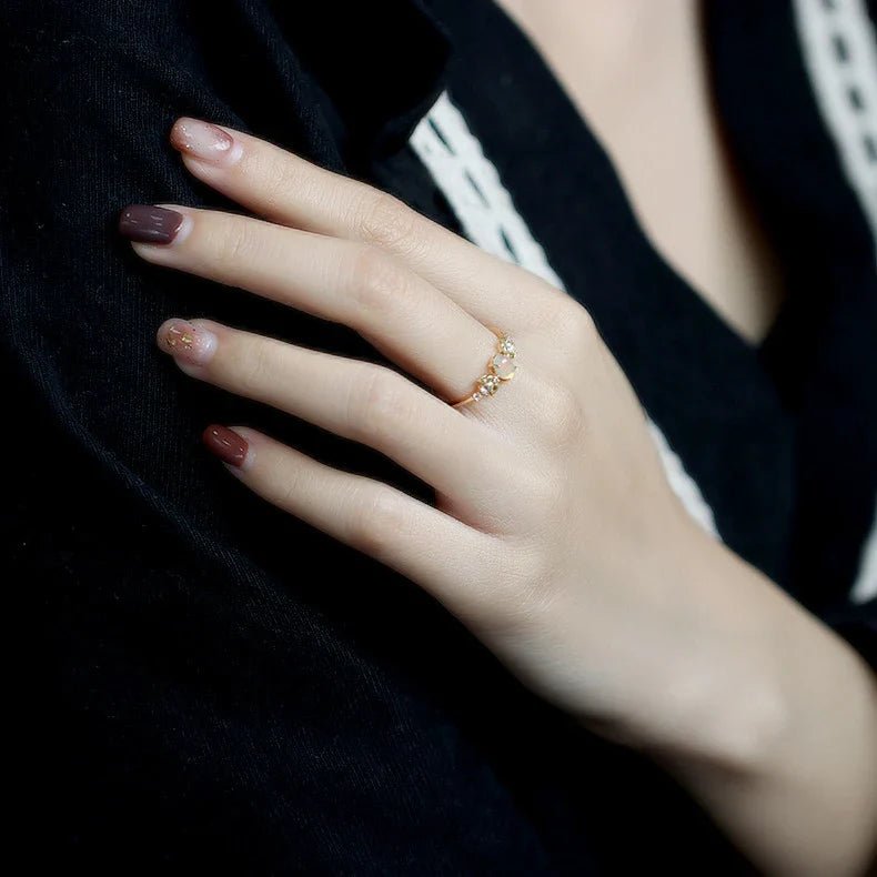 Sterling silver ring featuring a natural opal gemstone in a modern geometric design