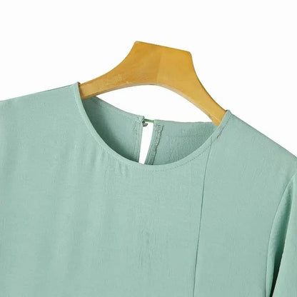 Elegant polyester dress with long sleeves, high slit hem, and available in caramel, black, blue, green, and pink colors