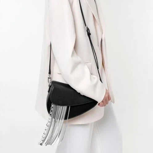 Premium leather crossbody saddle bag with stylish tassel detail, perfect for everyday use or formal occasions.