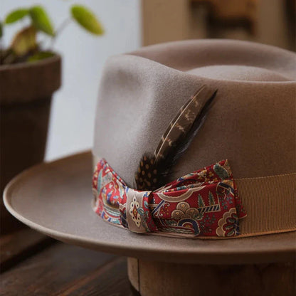 A beige wool top hat with a conical crown design, providing a classic and sophisticated look for formal and casual wear.