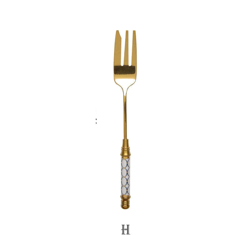 Elegant gold-plated dessert fork with intricate ceramic handle design