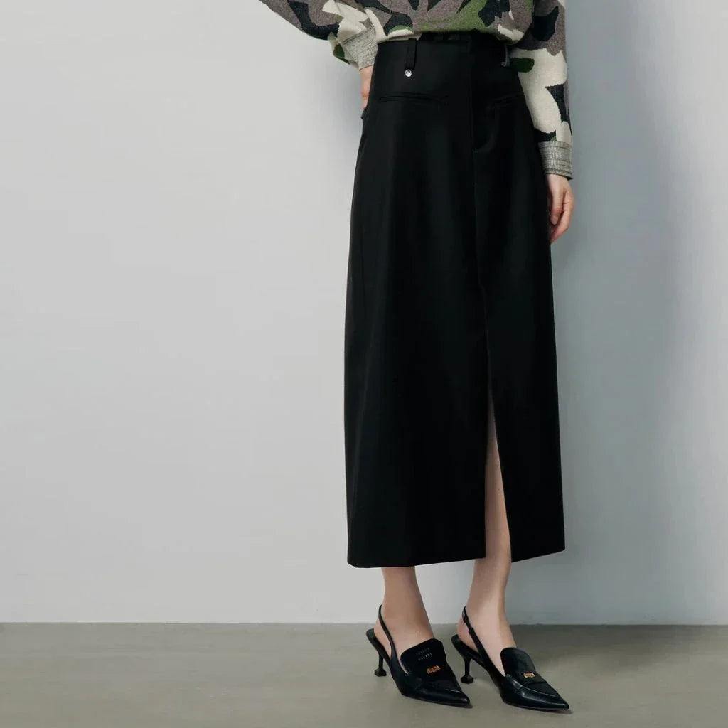 High-waisted slim-fit black midi skirt with metallic decoration, sequin detailing, and split hem