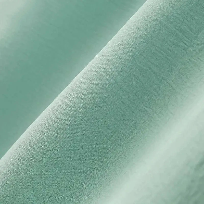 Elegant polyester dress with long sleeves, high slit hem, and available in caramel, black, blue, green, and pink colors