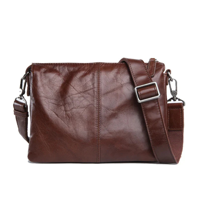 Premium cowhide leather crossbody bag with multiple interior pockets for organized, hands-free carrying