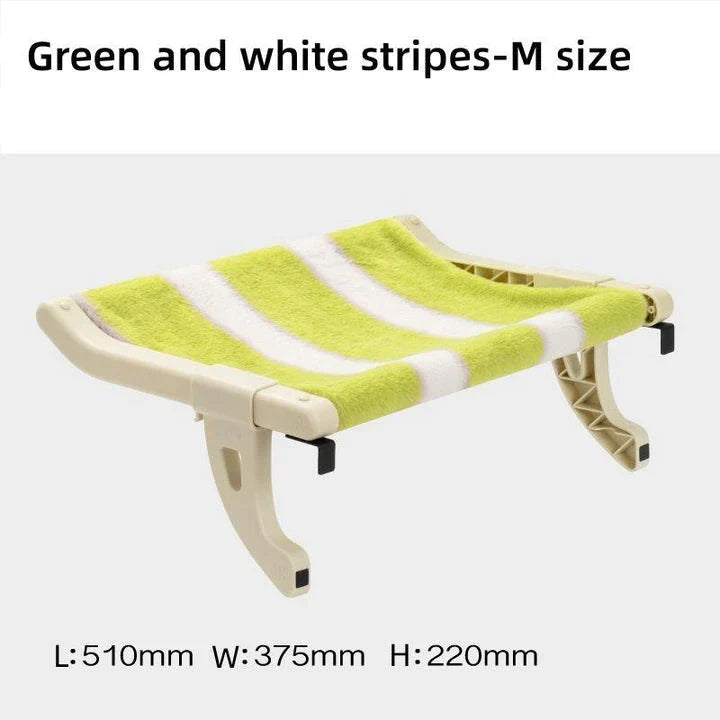 Cat relaxing in a cozy, hanging hammock bed placed in a sunny window