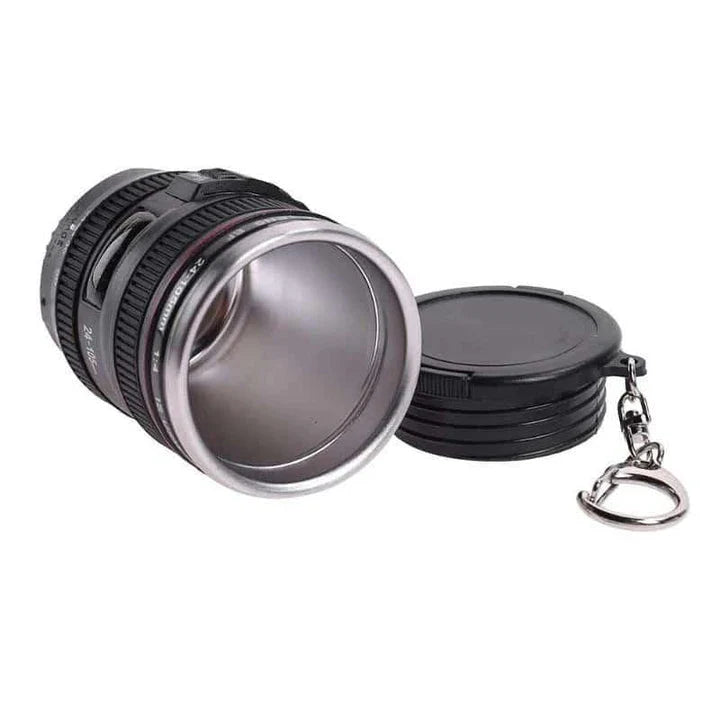 Stylish stainless steel and plastic shot glass with a miniature camera lens design, perfect for adding a unique touch to your home bar or cocktail setup.