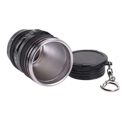 Stylish stainless steel and plastic shot glass with a miniature camera lens design, perfect for adding a unique touch to your home bar or cocktail setup.