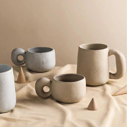 Handcrafted Japanese stoneware retro coffee mug in apricot and grey colors with a comfortable grip and minimalist design