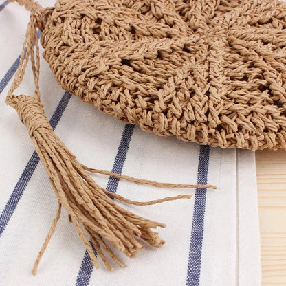 Bohemian rattan round crossbody bag in beige color with tassel accent, perfect for summer outings and beach parties