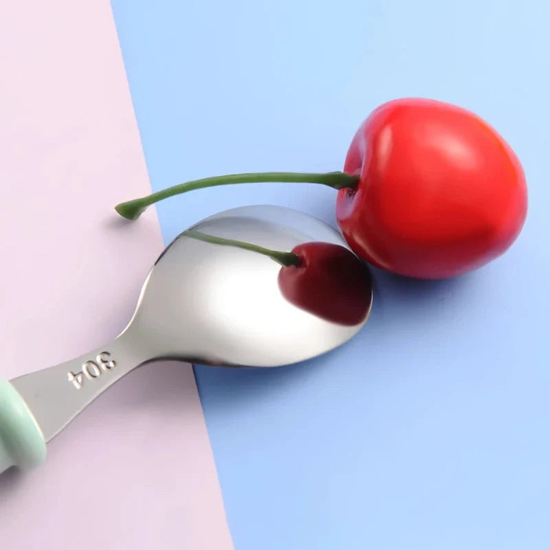 Charming cartoon-designed stainless steel toddler cutlery set with spoon and fork, perfect for mealtimes and self-feeding