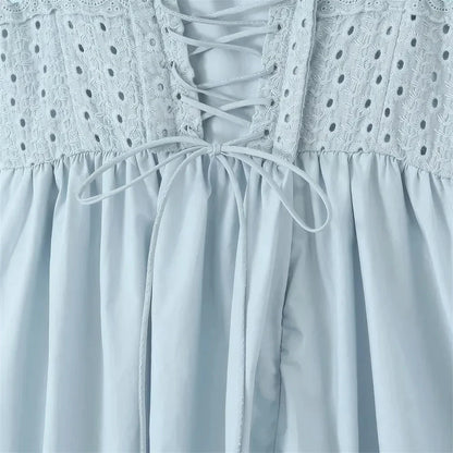 A stylish blue midi crochet dress with a floral pattern and spaghetti straps, perfect for summer occasions.