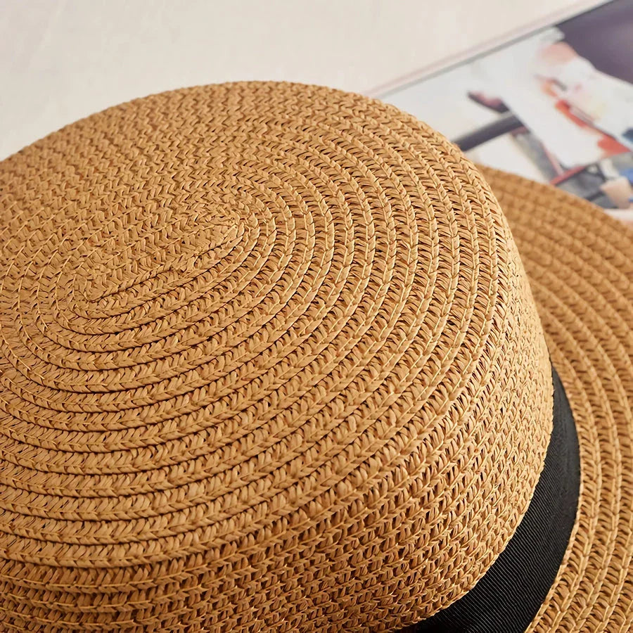Classic straw Panama hat with a bow detail, offering sun protection and fashionable summer style