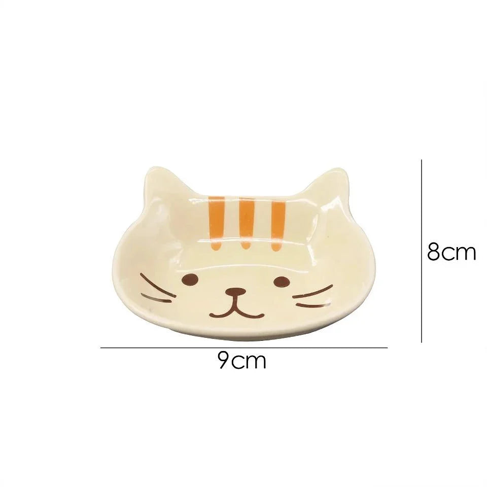 A charming Japanese-style ceramic dish featuring a cute cat design, perfect for serving sauces, dips, and small portions in style.