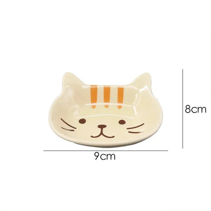 A charming Japanese-style ceramic dish featuring a cute cat design, perfect for serving sauces, dips, and small portions in style.