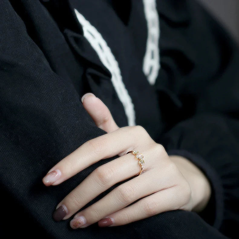 Sterling silver ring featuring a natural opal gemstone in a modern geometric design