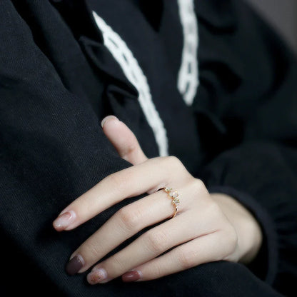 Sterling silver ring featuring a natural opal gemstone in a modern geometric design