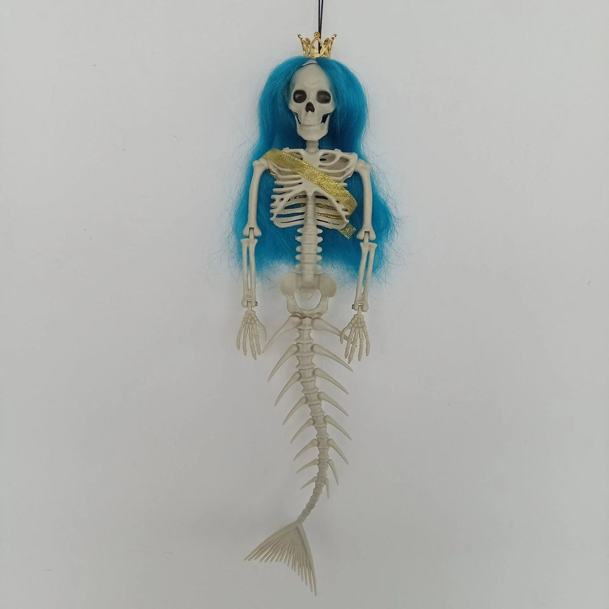 Mermaid bone pendant in various colors, including brown, dark purple, burgundy, and lake blue, hanging outdoors for Halloween decoration