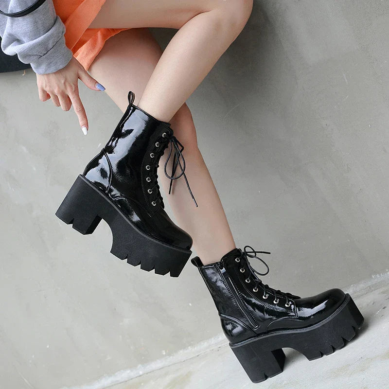 A pair of stylish lace-up high heel boots in black, featuring a sleek design and microfiber interior for comfort.