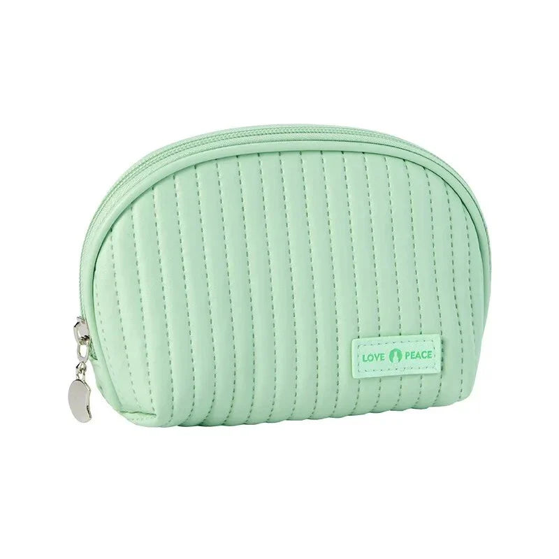 Stylish compact makeup bag made of premium PU leather in light blue color, with a sleek minimalist design for modern women