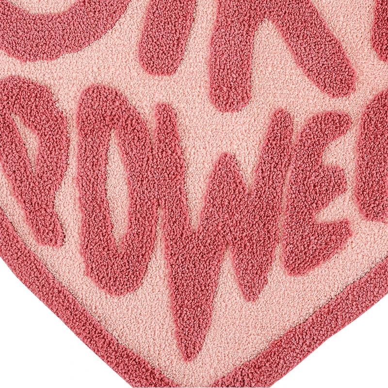 Cozy pink heart-shaped tufted rug with 'GRL PWR' message, perfect for girls' rooms, dressing rooms, and bathrooms