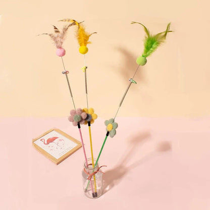 Interactive cat toy with furry ball, feathers, and bell for engaging playtime and exercise