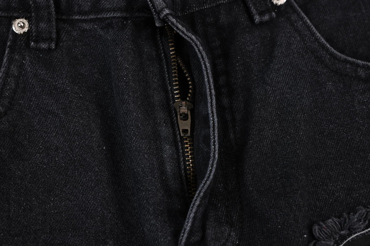 Premium loose fit distressed denim trousers for men and women, featuring a relaxed silhouette, high-quality cotton construction, and trendy distressed details.