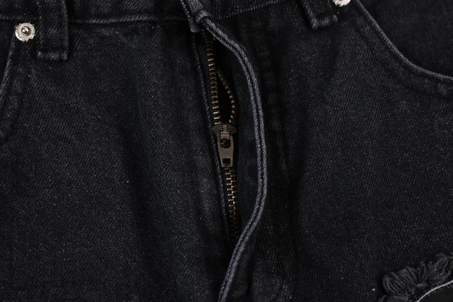 Premium loose fit distressed denim trousers for men and women, featuring a relaxed silhouette, high-quality cotton construction, and trendy distressed details.