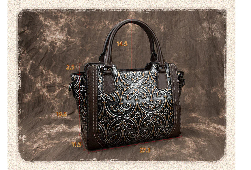 A fashionable large capacity leather shoulder bag for women in a vintage-inspired floral design with multiple interior pockets for organization.