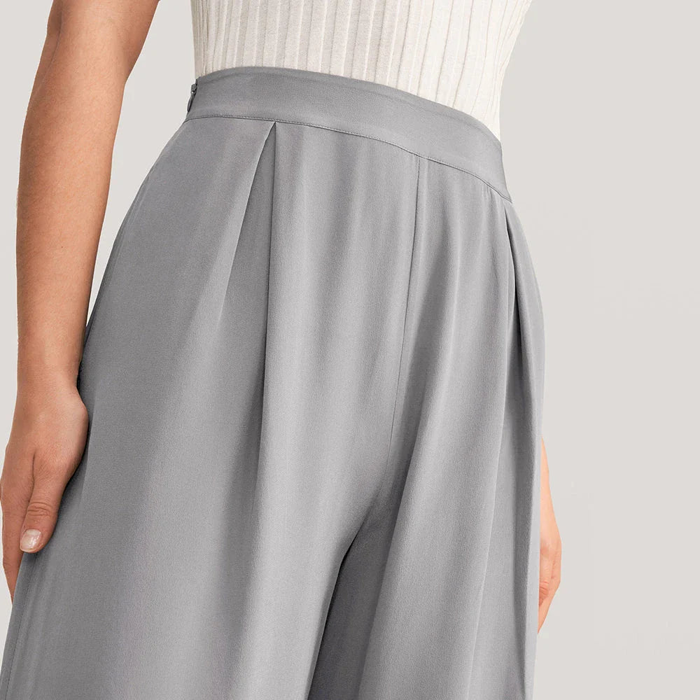 Elegant grey silk wide-leg pants with a high-waist design and concealed side zipper for a flattering, comfortable fit.
