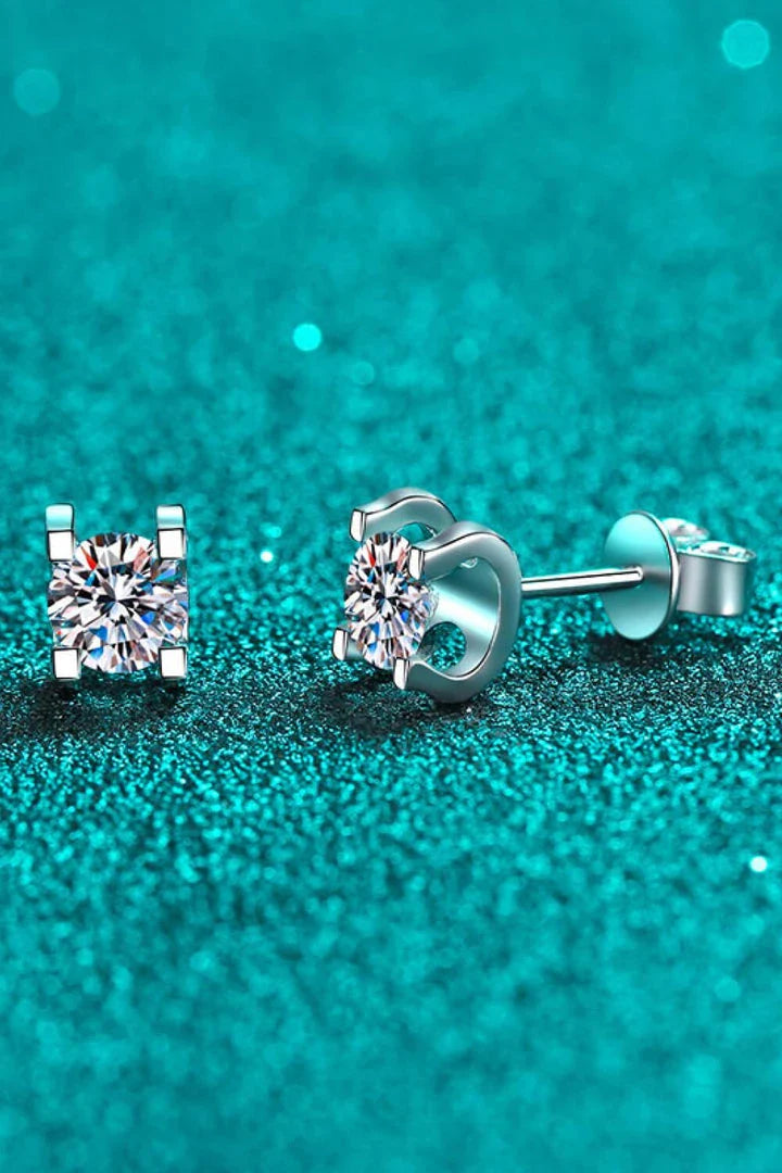 A pair of 1 carat moissanite stud earrings made of 925 sterling silver with a rhodium plating for a dazzling shine.