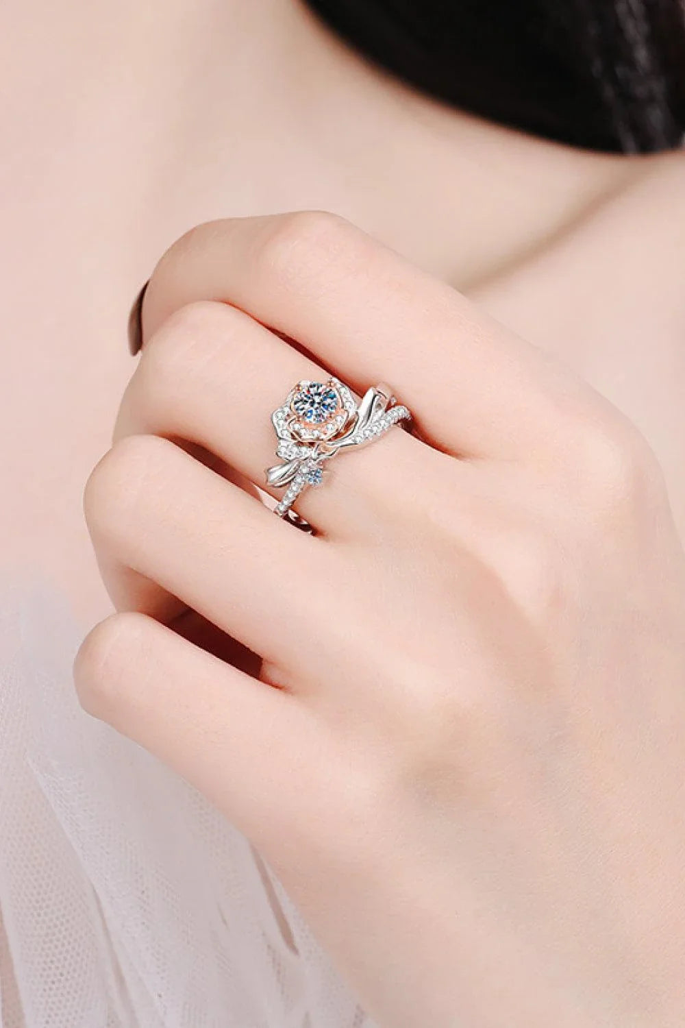Elegant rose-shaped moissanite ring in sterling silver with a sparkling center stone and zircon accents