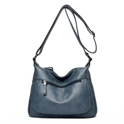 Stylish one-shoulder messenger bag in various colors with a soft, supple PU leather exterior and a spacious, organized main compartment