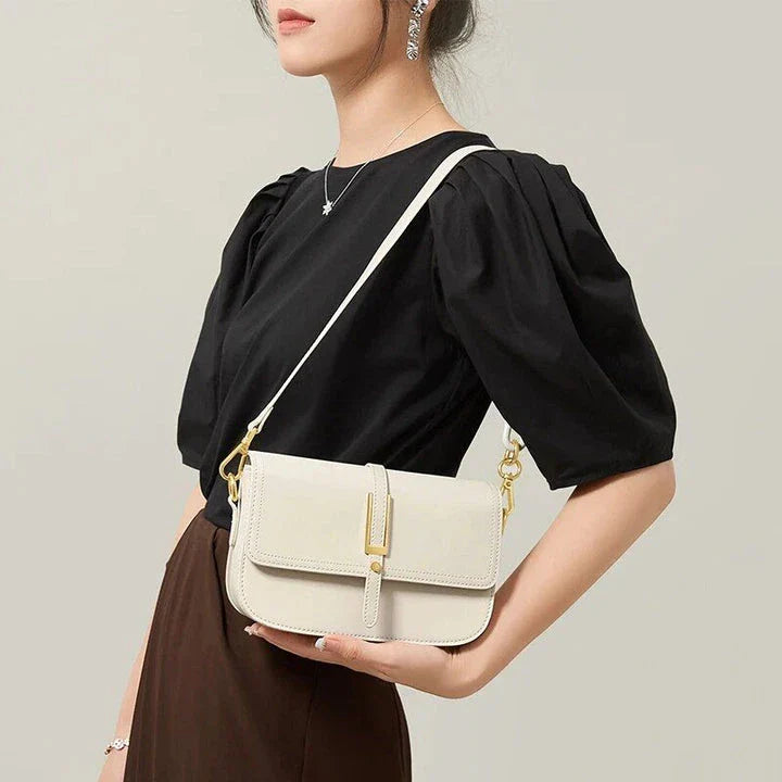 Elegant white leather crossbody bag for women with adjustable strap and multiple interior pockets for organized storage.