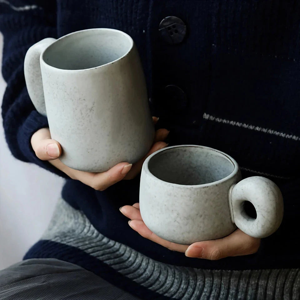 Handcrafted Japanese stoneware retro coffee mug in apricot and grey colors with a comfortable grip and minimalist design