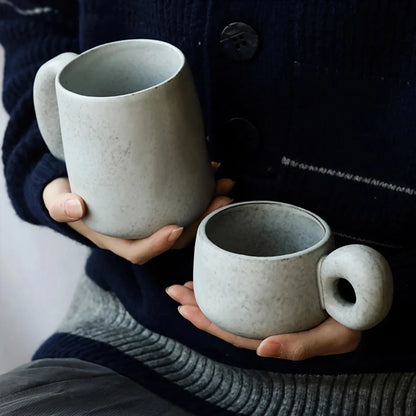 Handcrafted Japanese stoneware retro coffee mug in apricot and grey colors with a comfortable grip and minimalist design