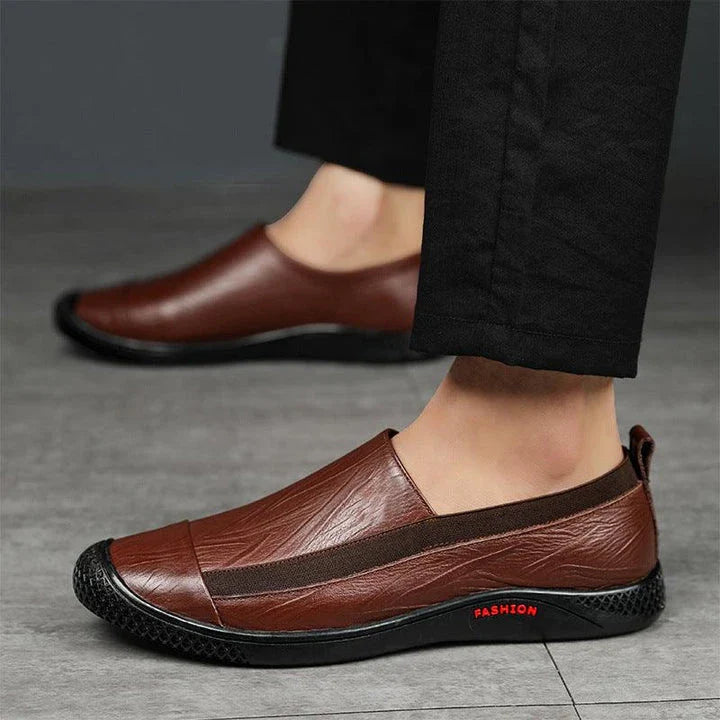 A pair of durable and stylish men's casual leather shoes in black, featuring a pointed toe, low upper, and rubber sole.