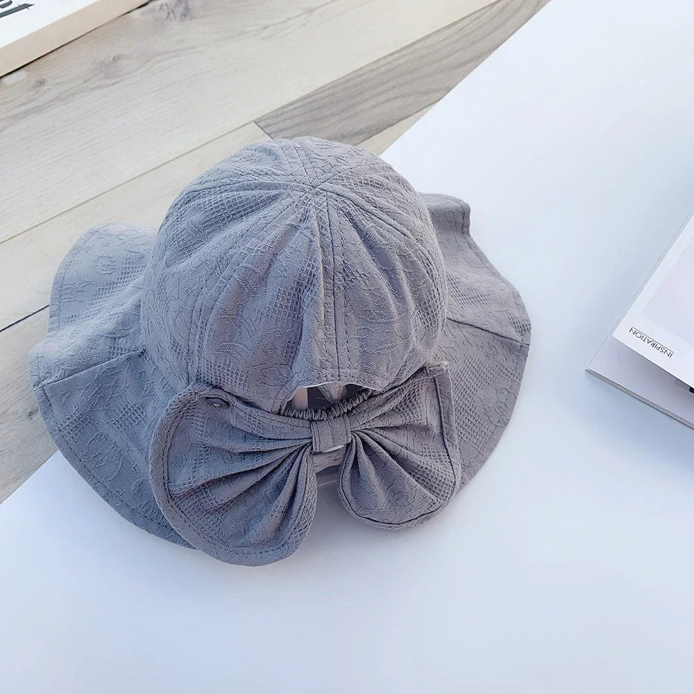 Adorable princess-inspired baby bucket hat with soft cotton material and wide brim for sun protection