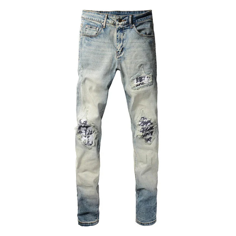 American High Street fashionable men's ripped black and white patch jeans in a light blue denim color