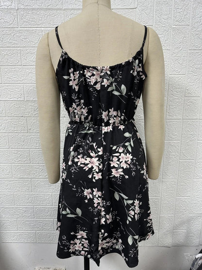 A stylish floral print suspender dress with an elastic waist, perfect for summer fashion and casual or dressy occasions.