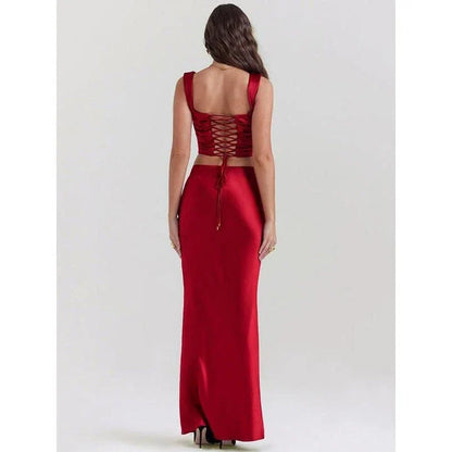Elegant satin two-piece formal skirt set with backless crop top and ankle-length skirt in a sophisticated wine color