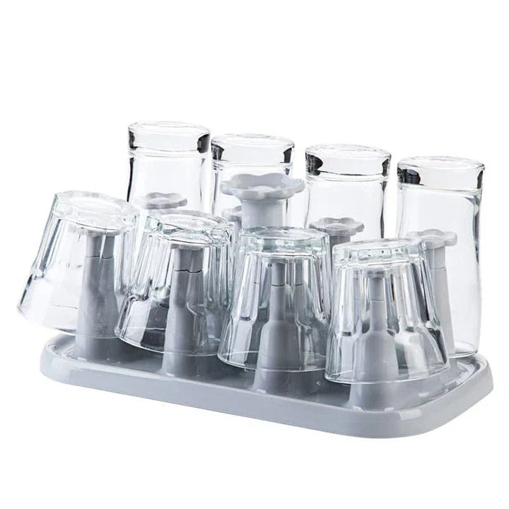 Flower-shaped mug holder rack in white, with 8 slots for organizing and displaying mugs on a kitchen countertop