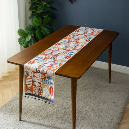 Festive jacquard table runner with vibrant fish design, available in multiple sizes to fit various dining tables